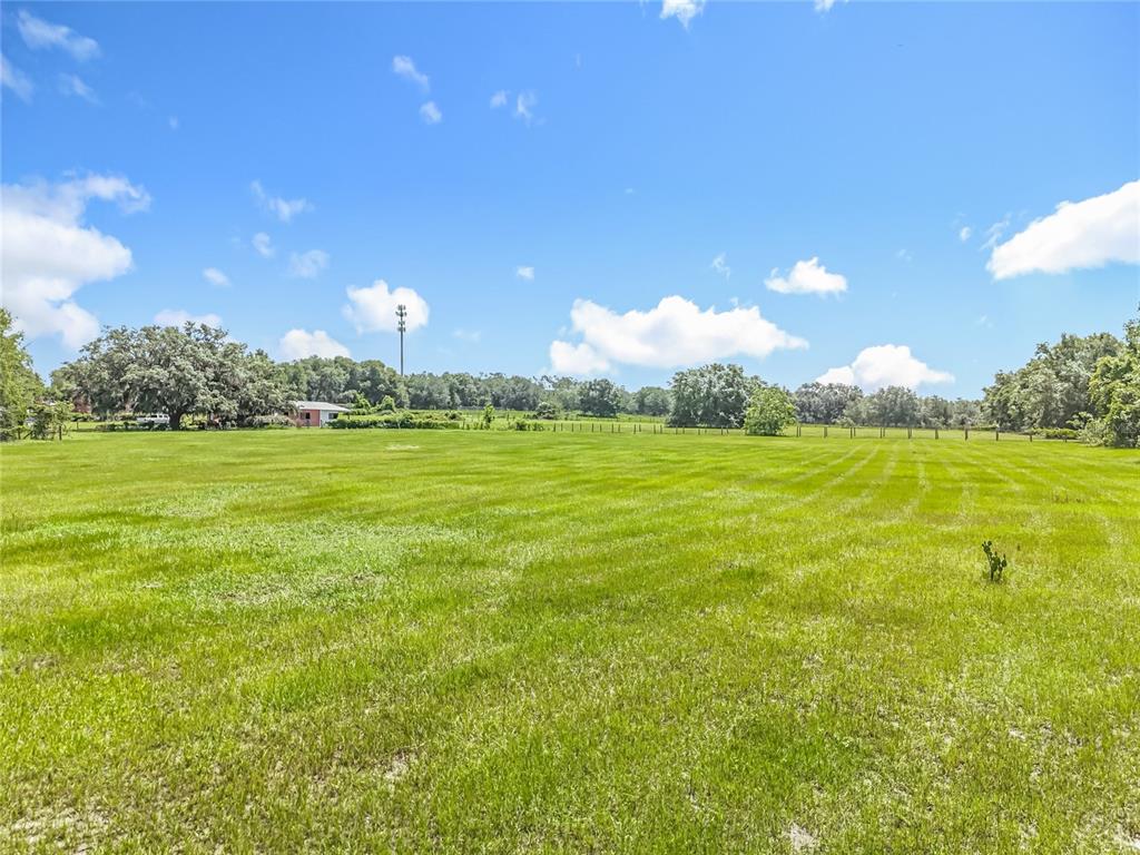 41204 Emeralda Island Road Leesburg, FL 34788 - Photo 37 of 53 a view of a large building with yard in front of it
