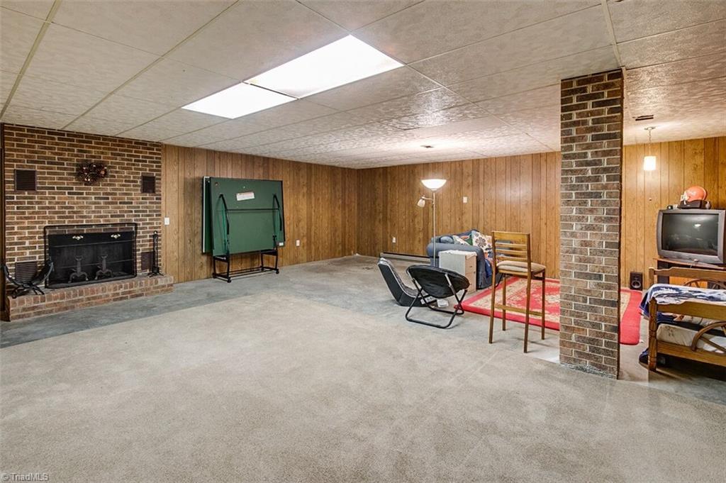 5902 Dehaven Road Pleasant Garden, NC 27313 - Photo 21 of 27 Finished basement with fireplace for relaxing or entertainment