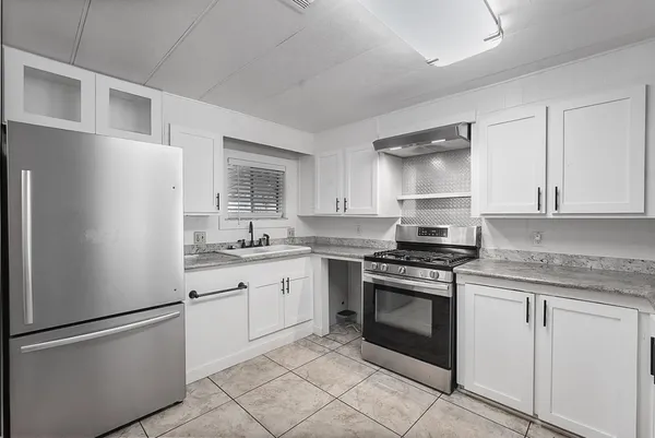 a kitchen with refrigerator and microwave