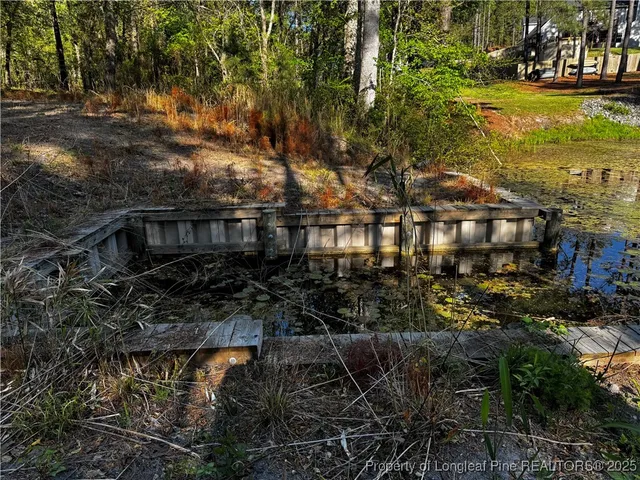 a view of a house with a yard next to a lake