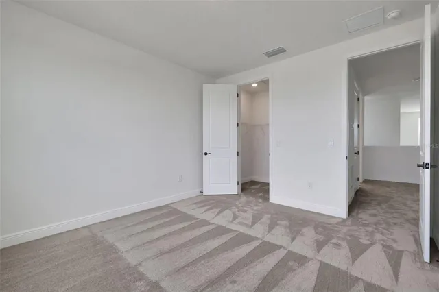 a bathroom with a double vanity sink toilet and mirror