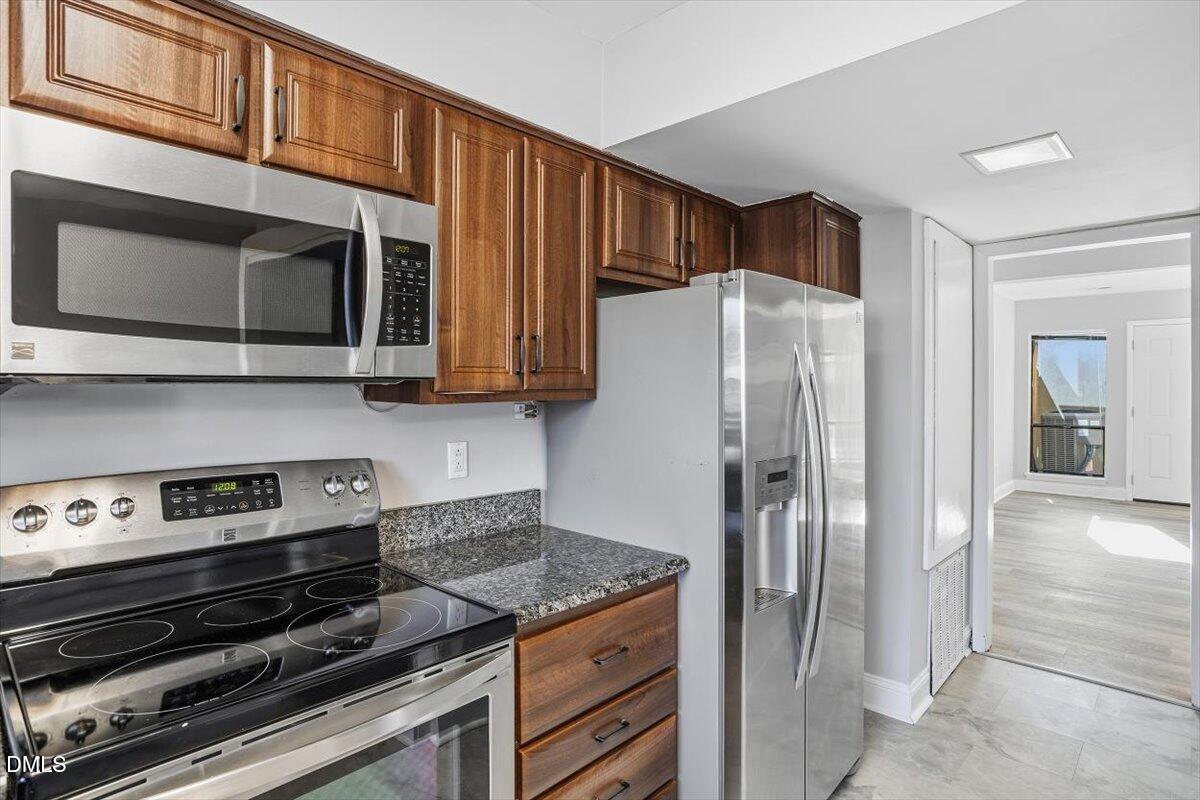 5021 Tall Pines Court Raleigh, NC 27609 - Photo 12 of 30 a kitchen with stainless steel appliances granite countertop a refrigerator and a stove top oven
