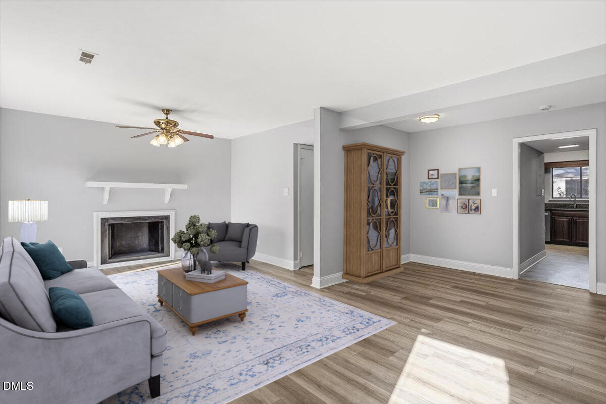 5021 Tall Pines Court Raleigh, NC 27609 - Photo 14 of 30 a living room with furniture and a fireplace