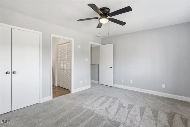 a view of a big room with a ceiling fan