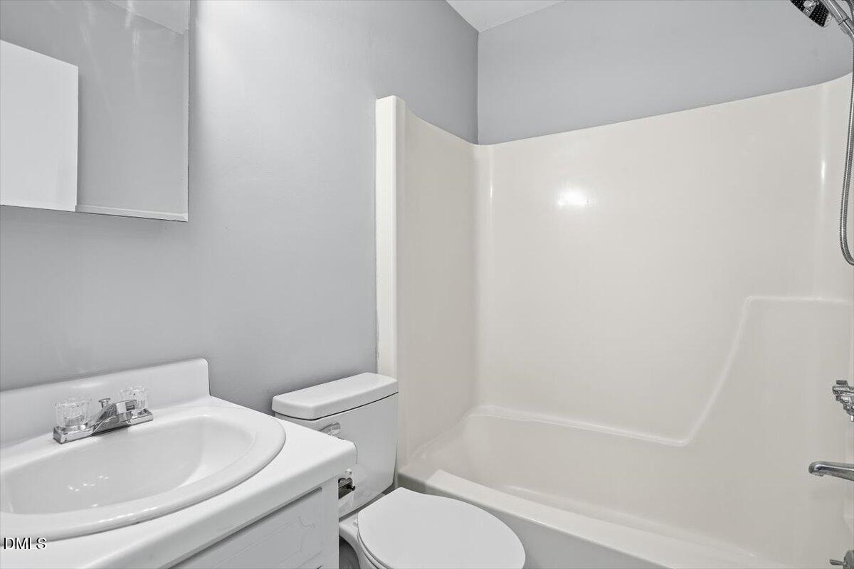 5021 Tall Pines Court Raleigh, NC 27609 - Photo 24 of 30 a white toilet sitting next to a bath tub