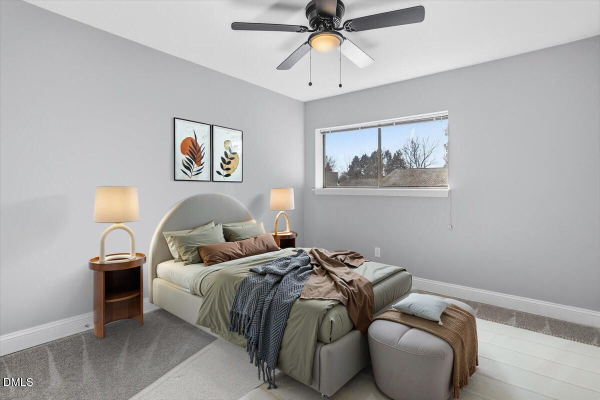 5021 Tall Pines Court Raleigh, NC 27609 - Photo 25 of 30 a bed room with a bed and a painting on the wall