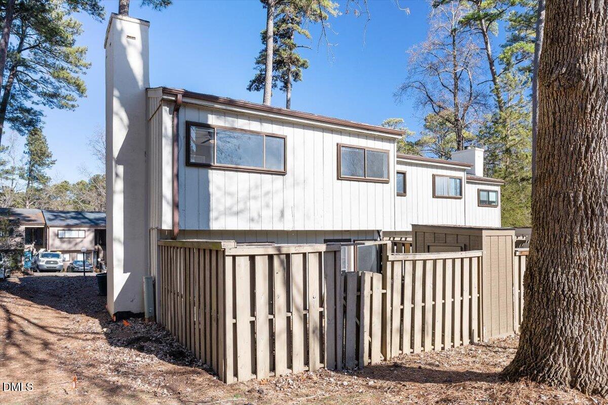5021 Tall Pines Court Raleigh, NC 27609 - Photo 29 of 30 a view of a house with a small yard and wooden fence