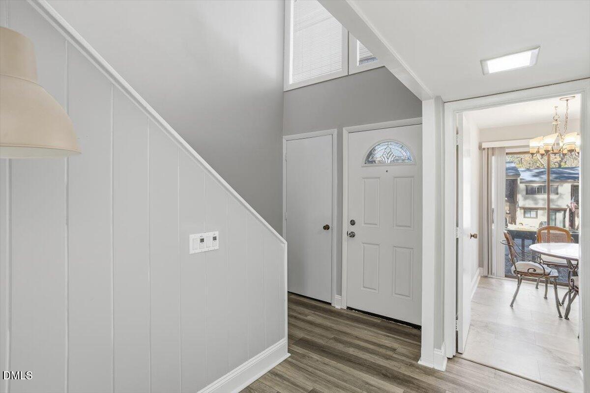 5021 Tall Pines Court Raleigh, NC 27609 - Photo 4 of 30 a view of a hallway with wooden floor and staircase