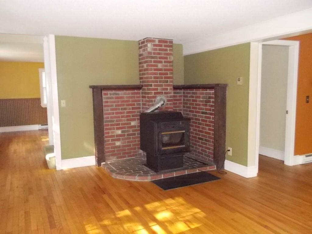 28 Upper Spruce Shore Road Harpswell, ME 04079 - Photo 9 of 21 Living room pellet stove on brick...