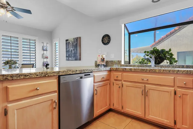 a kitchen with stainless steel appliances granite countertop a sink and a cabinets