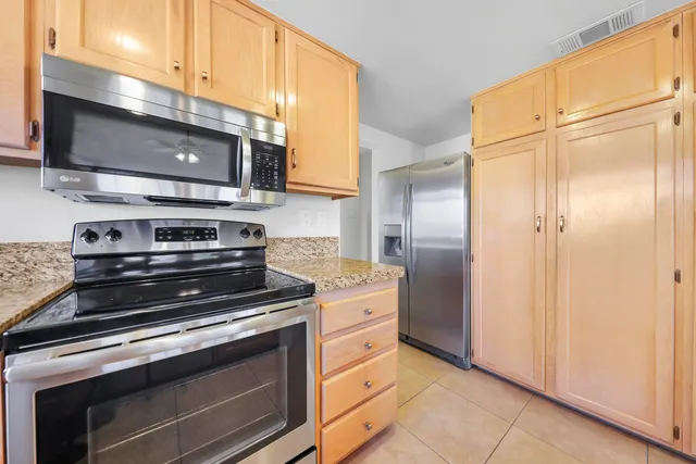 a kitchen with stainless steel appliances and cabinets