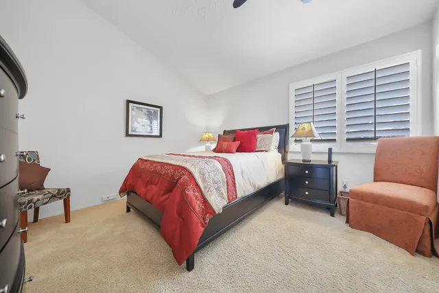 a bedroom with a bed couch and a window