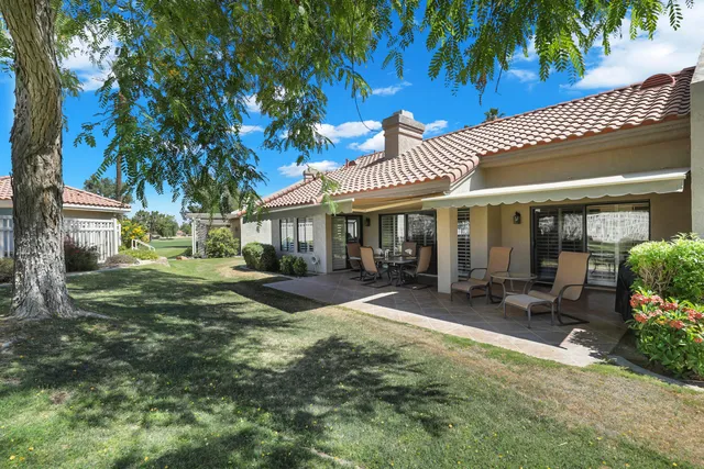a view of a house with backyard porch and sitting area