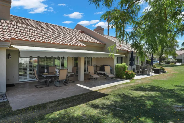 a view of a patio with table and chairs and potted plants