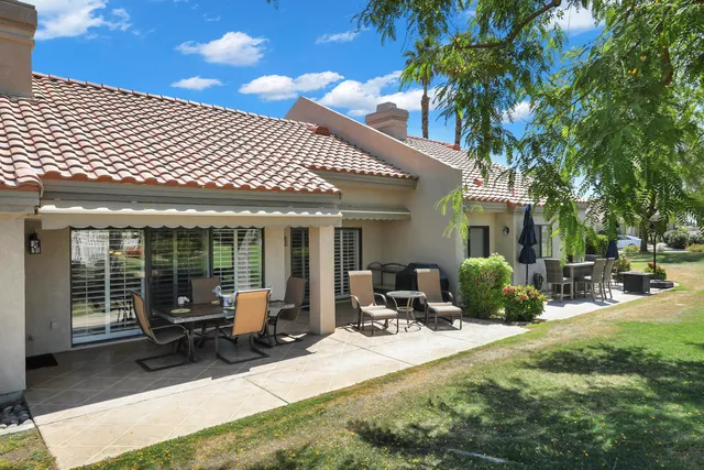 a view of a house with backyard porch and sitting area