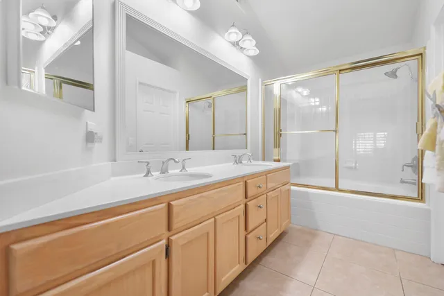 a bathroom with a double vanity sink and a mirror