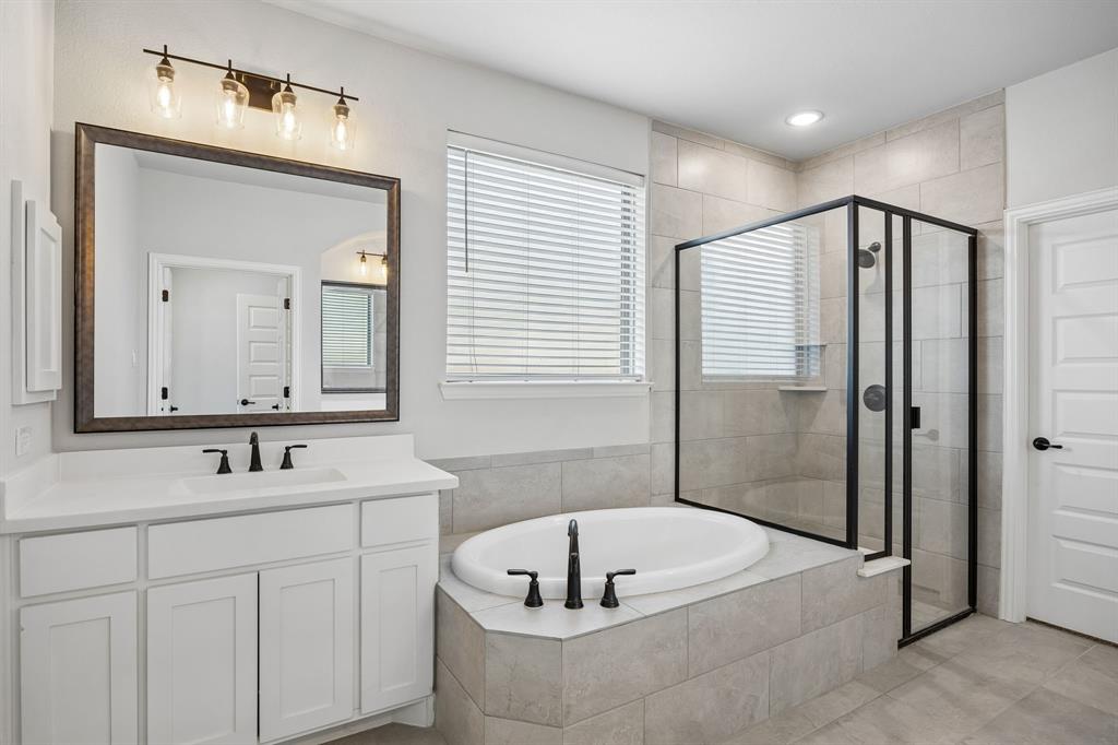 117 Joshua Tree Court Forney, TX 75126 - Photo 17 of 29 a bathroom with a tub a sink and mirror