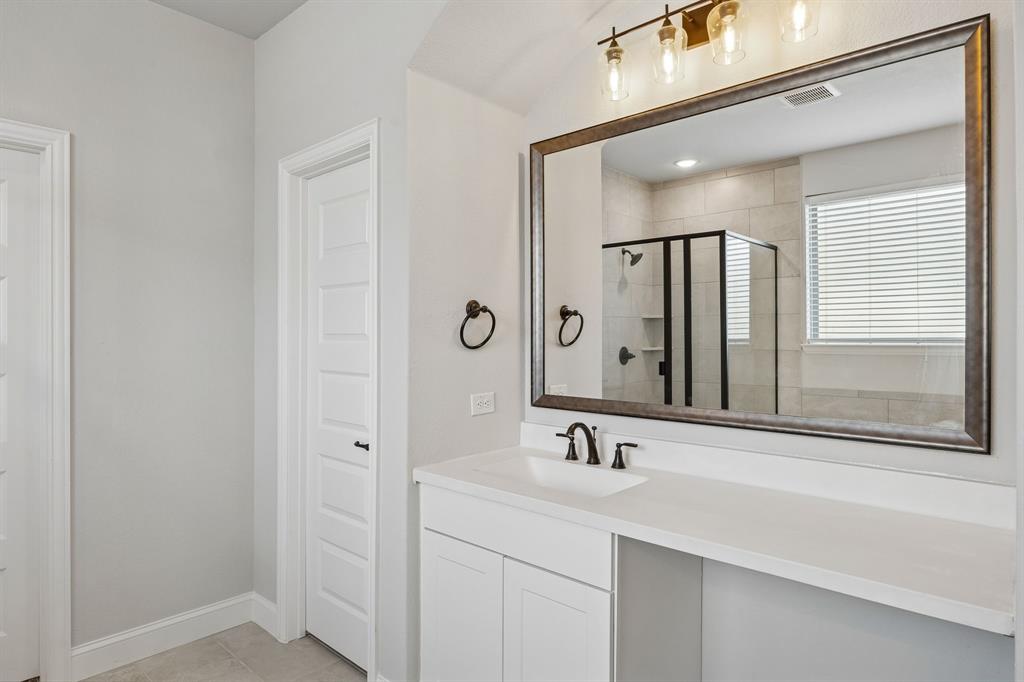 117 Joshua Tree Court Forney, TX 75126 - Photo 18 of 29 a bathroom with a sink and a mirror