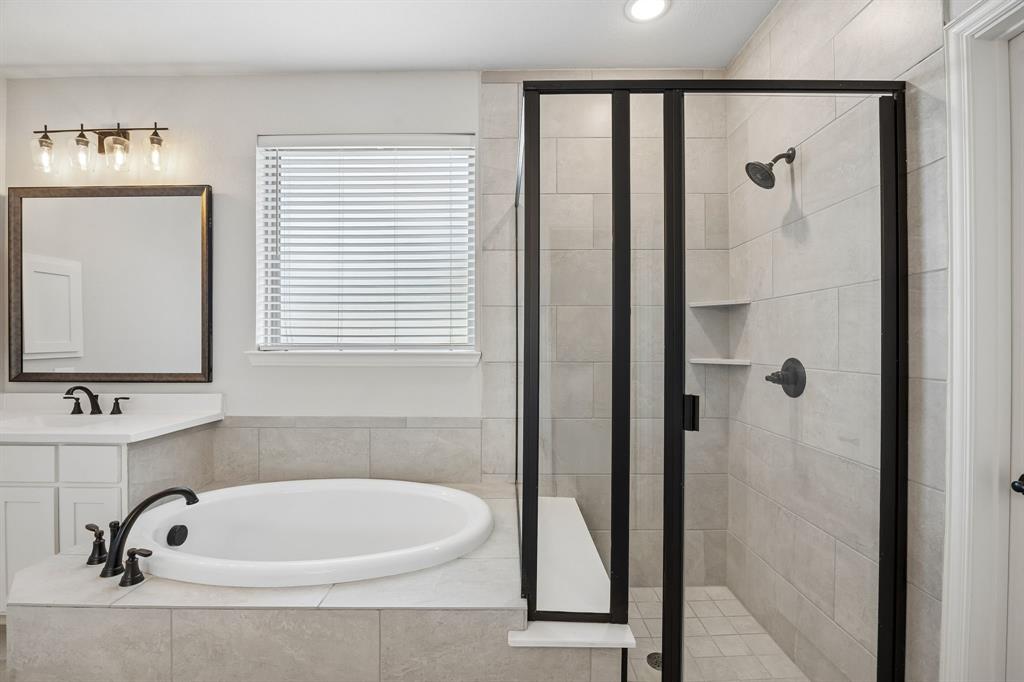 117 Joshua Tree Court Forney, TX 75126 - Photo 19 of 29 a bathroom with a tub a sink and a window
