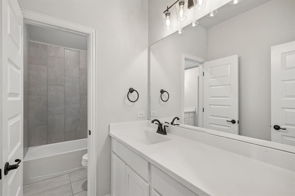 117 Joshua Tree Court Forney, TX 75126 - Photo 24 of 29 a bathroom with a sink a shower and a mirror
