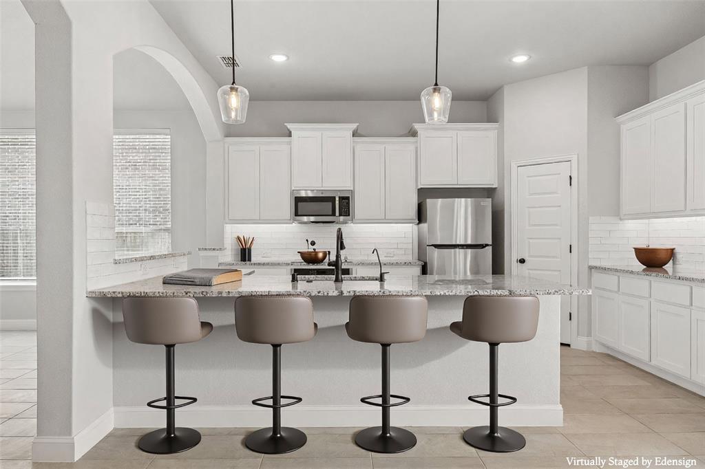 117 Joshua Tree Court Forney, TX 75126 - Photo 7 of 29 a view of kitchen with stainless steel appliances kitchen island granite countertop a dining table chairs and sink
