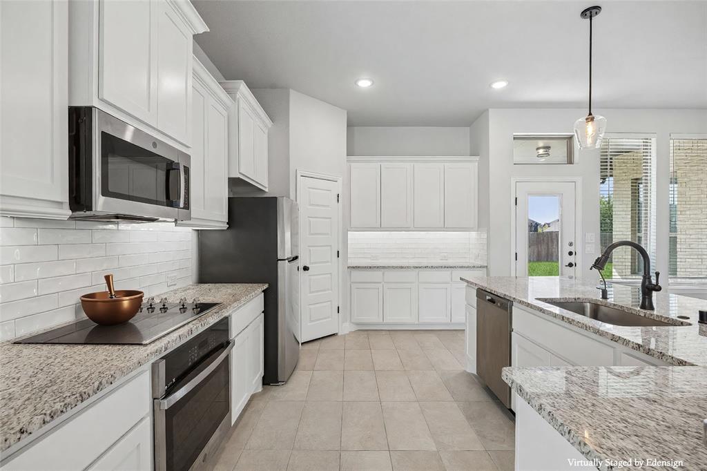 117 Joshua Tree Court Forney, TX 75126 - Photo 9 of 29 a kitchen with stainless steel appliances granite countertop a sink and a stove