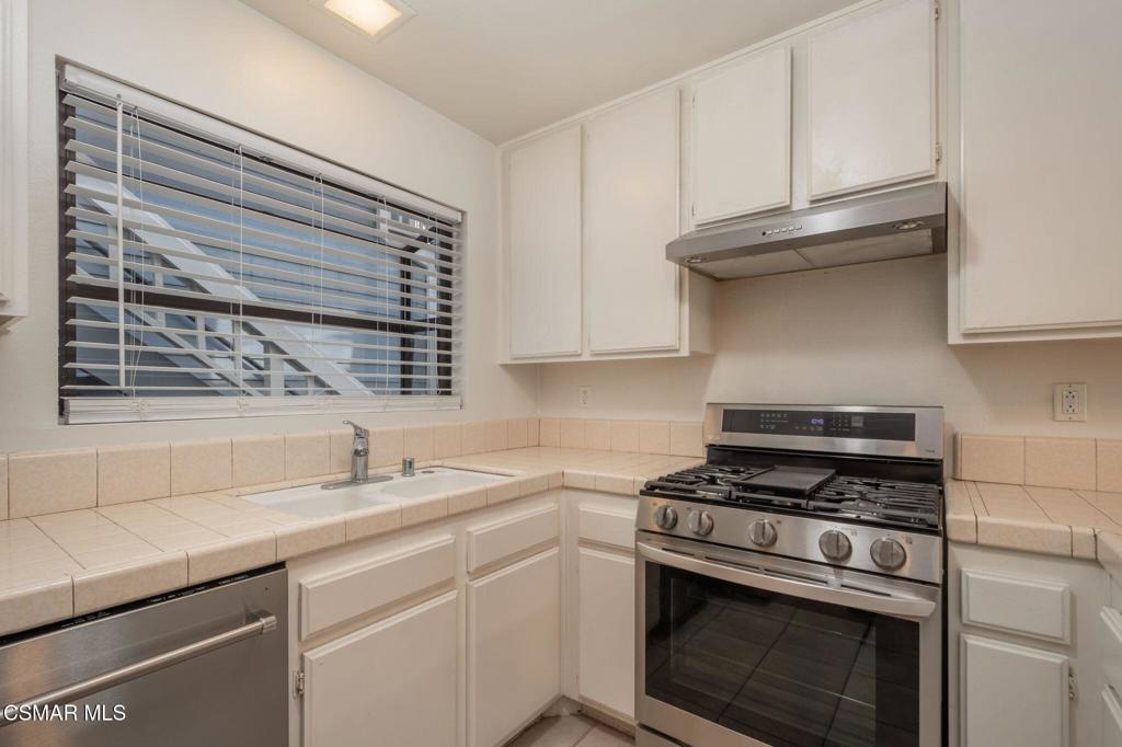 647 Arneill Road Camarillo, CA 93010 - Photo 10 of 27 a kitchen with granite countertop a sink stainless steel appliances and cabinets