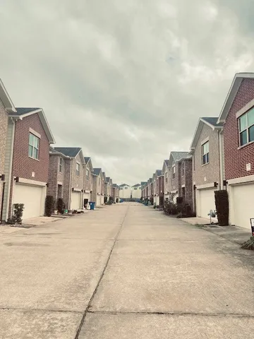 a view of a city street with tall buildings