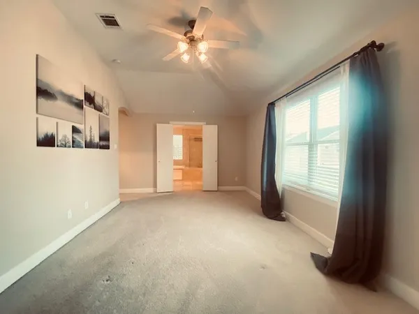 a view of a livingroom with a ceiling fan and window