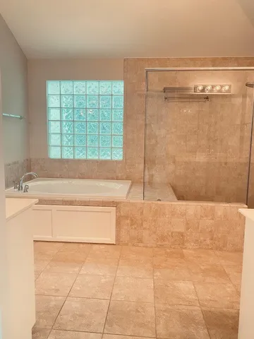 a bathroom with a bathtub and a shower