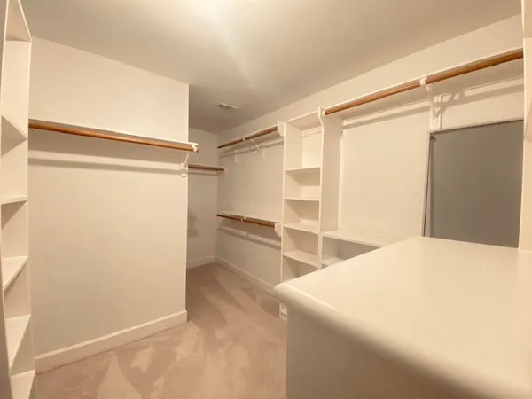 a bedroom with a bed and a refrigerator