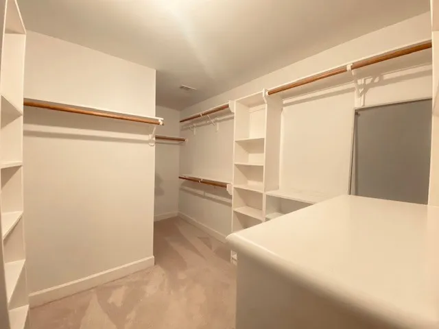 a bedroom with a bed and a refrigerator