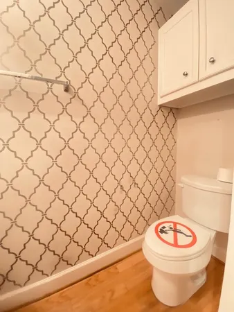 a bathroom with a white toilet and a sink