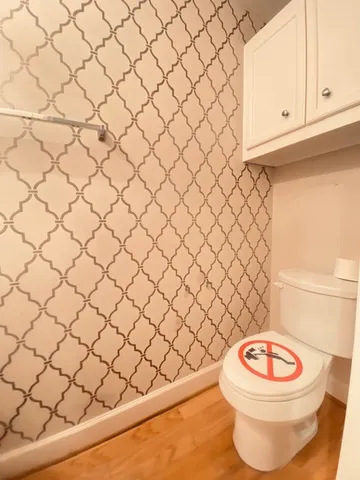 a bathroom with a white toilet and a sink