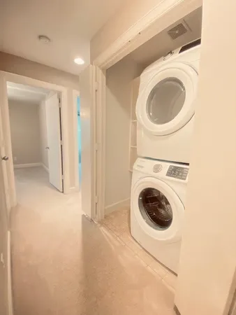 a view of a hallway with washer and dryer