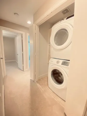 a view of a hallway with washer and dryer