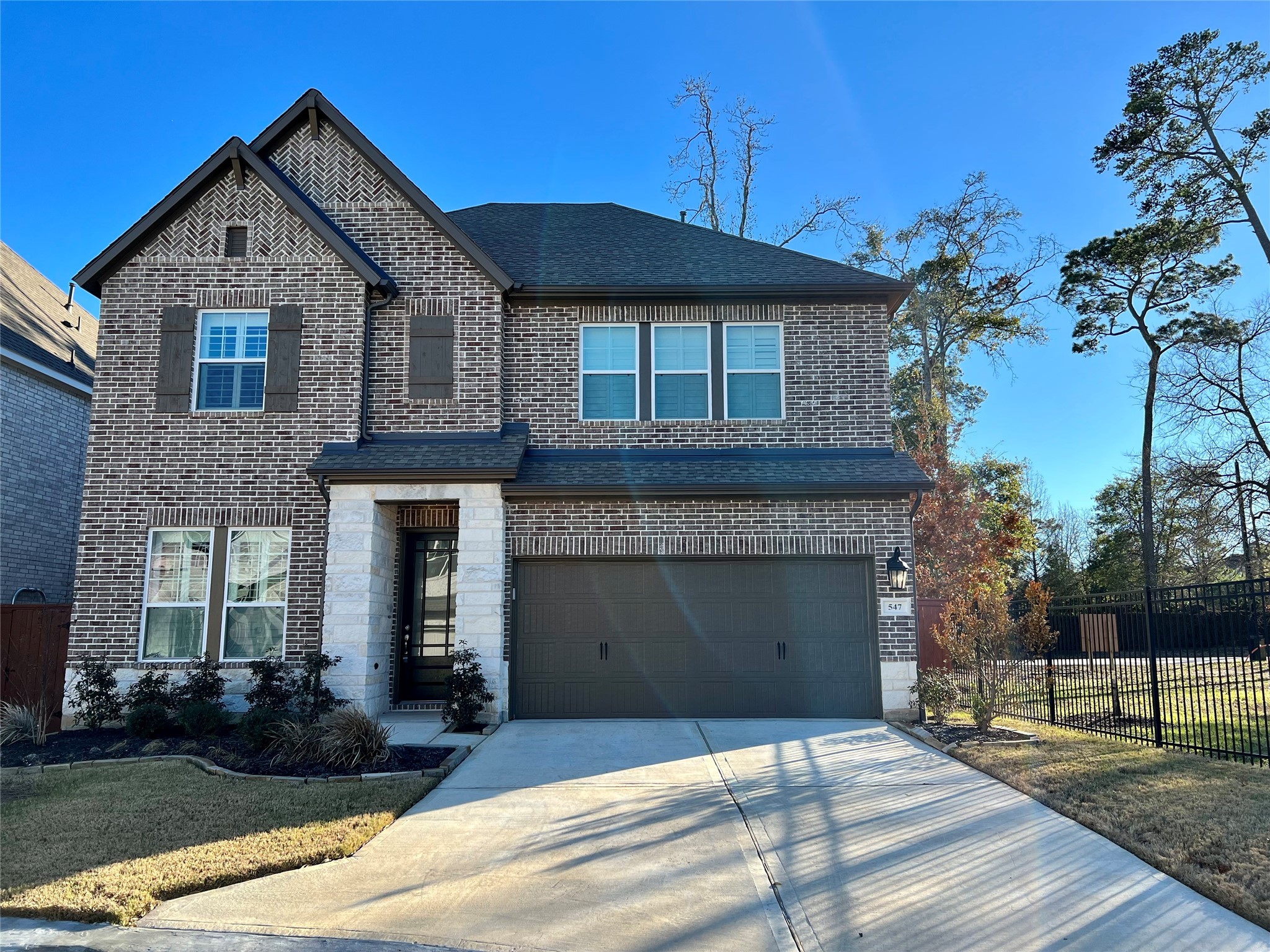 547 Kingston Lane Conroe, TX 77384 - Photo 1 of 50 a front view of a house with yard and parking