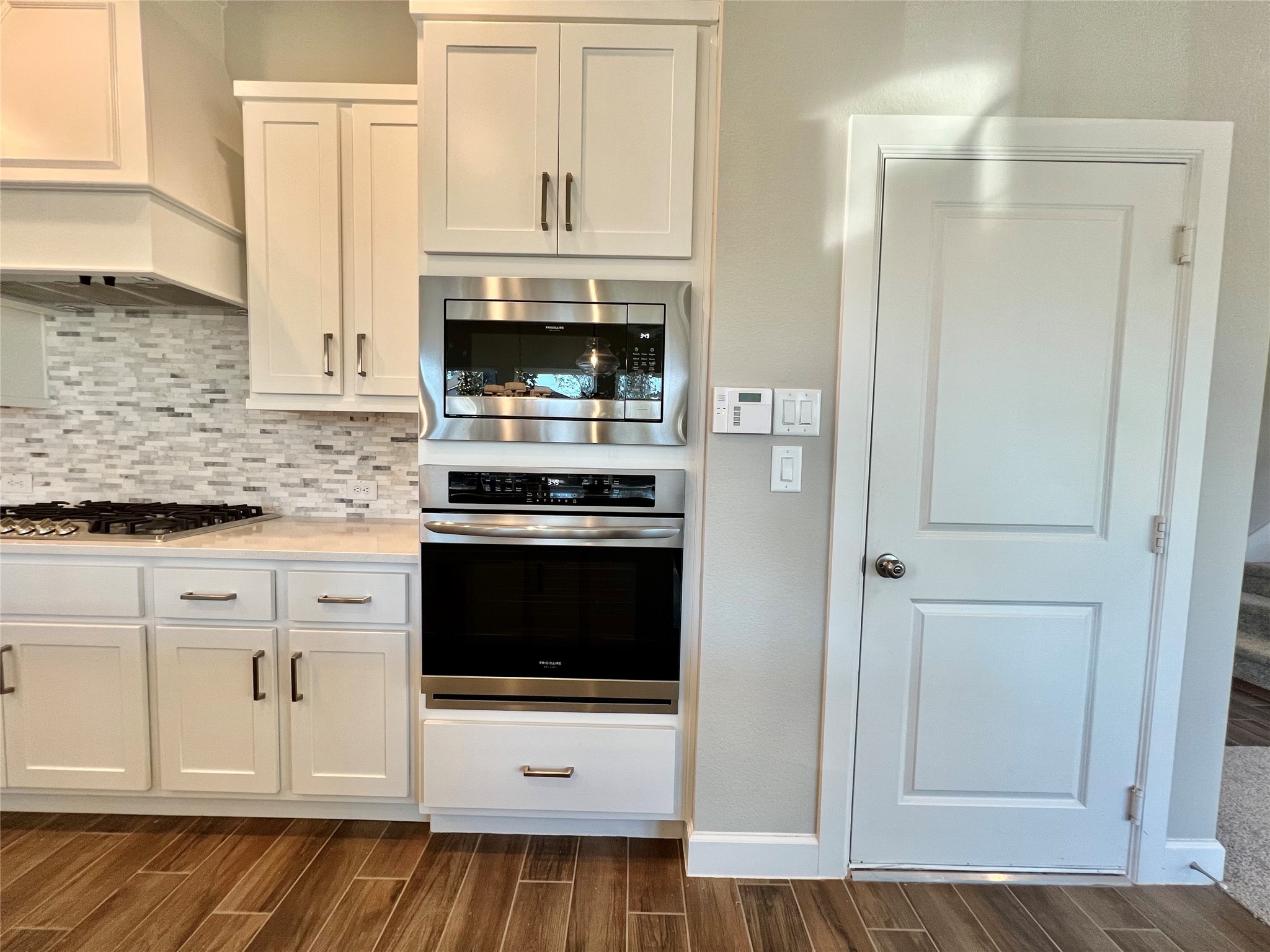 547 Kingston Lane Conroe, TX 77384 - Photo 14 of 50 a kitchen with stainless steel appliances granite countertop a stove a microwave and a refrigerator