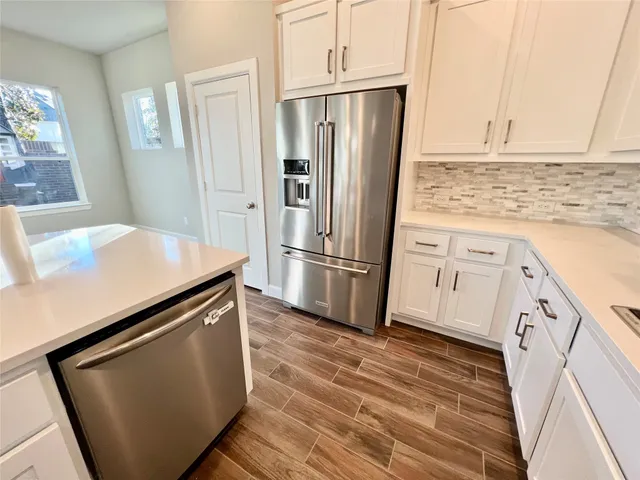 a refrigerator freezer sitting inside of a kitchen