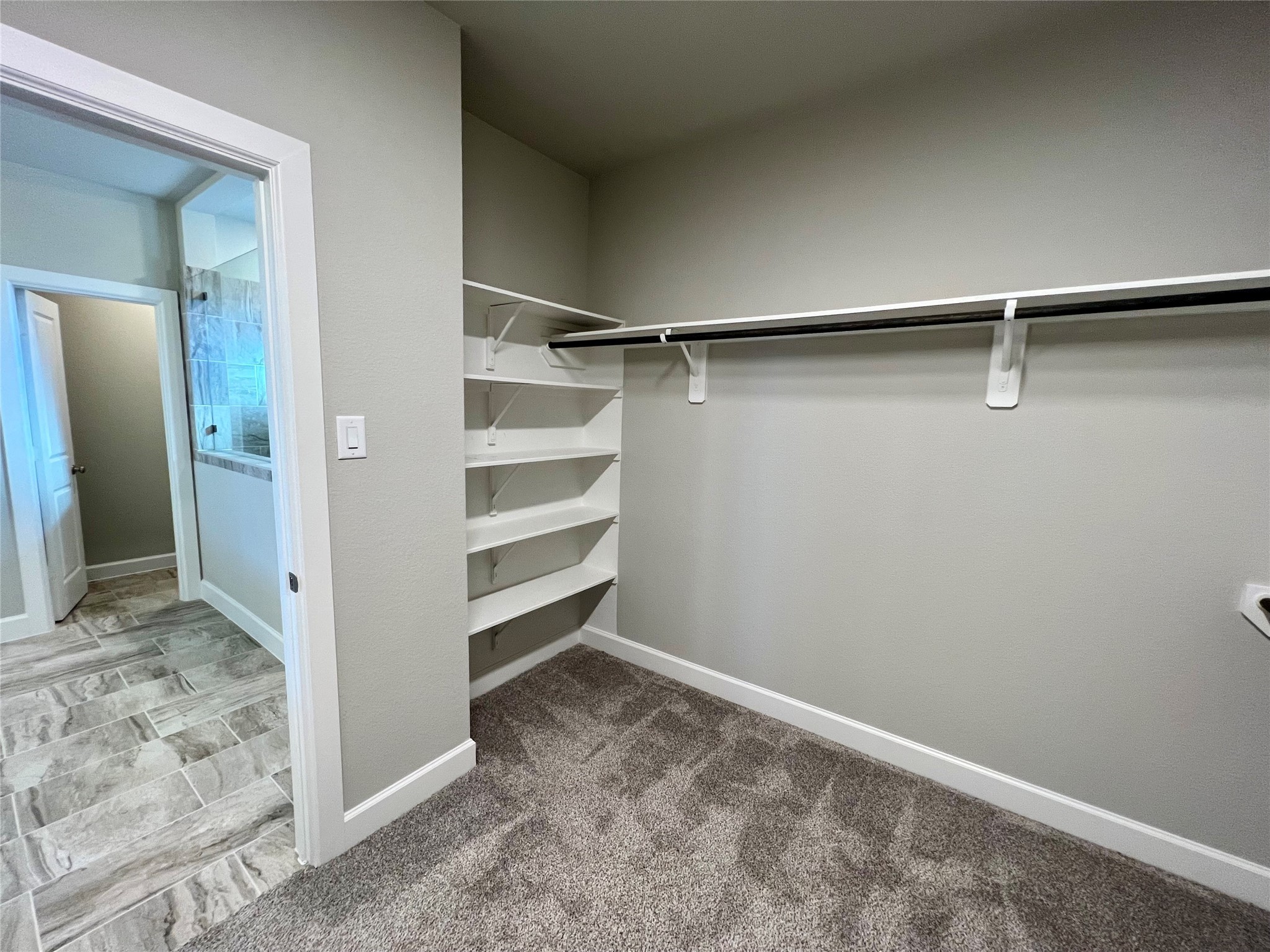 547 Kingston Lane Conroe, TX 77384 - Photo 33 of 50 a view of walk in closet with empty racks