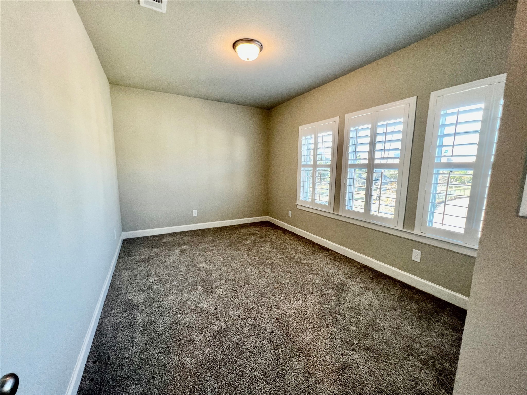 547 Kingston Lane Conroe, TX 77384 - Photo 39 of 50 an empty room with a empty space and windows