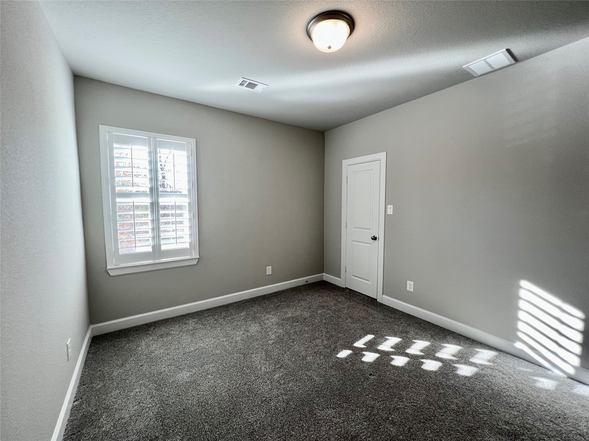 547 Kingston Lane Conroe, TX 77384 - Photo 45 of 50 an empty room with windows and painted walls