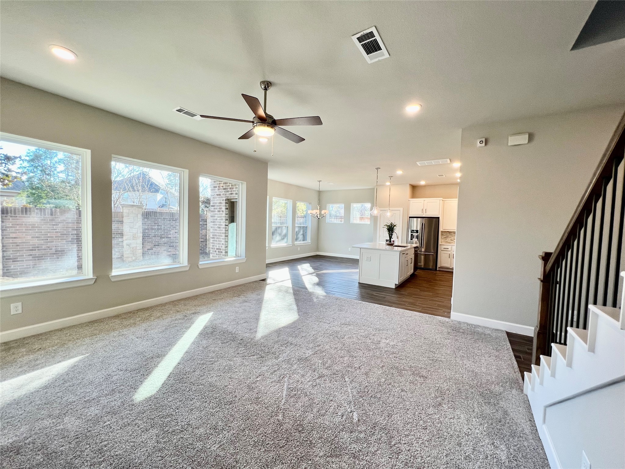 547 Kingston Lane Conroe, TX 77384 - Photo 9 of 50 a view of a living room and kitchen floor to ceiling windows