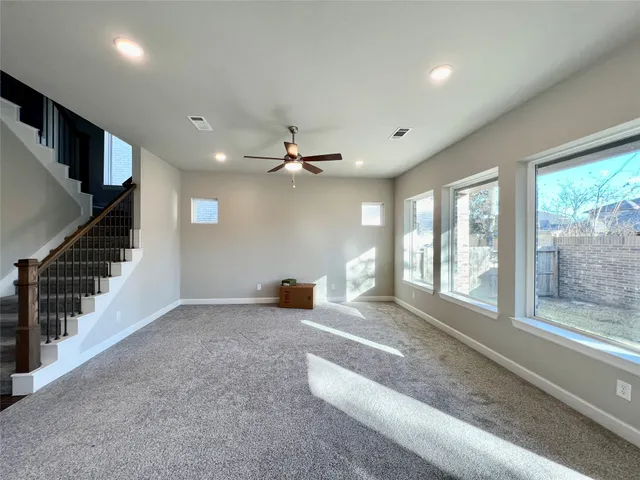 a large kitchen with granite countertop a stove a sink dishwasher and a fireplace with wooden floor