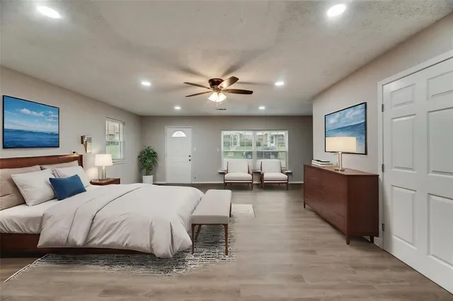 a spacious bedroom with a large bed and a window