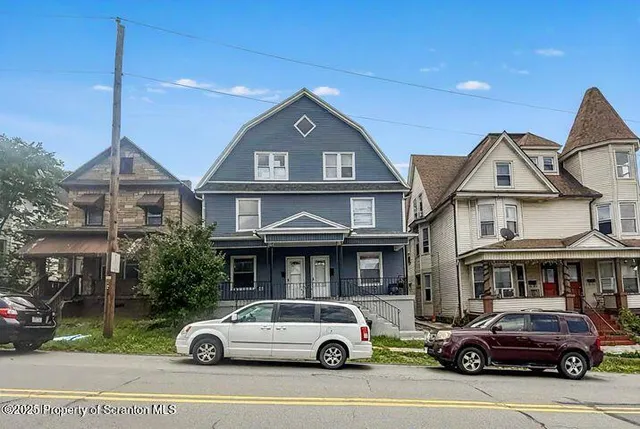 a front view of a residential apartment building with a yard