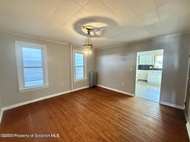 508 Harrison Avenue Scranton, PA 18510 - Photo 2 of 10 an empty room with wooden floor mirror and windows
