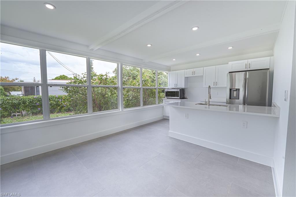 7233 Coolidge Road Fort Myers, FL 33967 - Photo 11 of 36 a view of kitchen with furniture and refrigerator