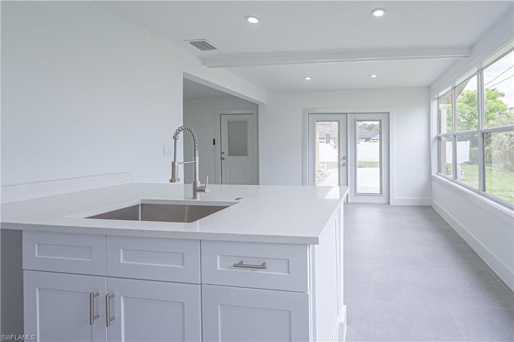 7233 Coolidge Road Fort Myers, FL 33967 - Photo 13 of 36 a kitchen with a sink and large window