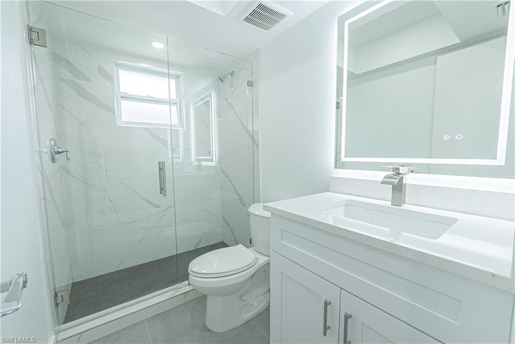 7233 Coolidge Road Fort Myers, FL 33967 - Photo 21 of 36 a bathroom with a sink a toilet and shower